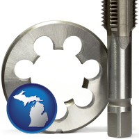 michigan map icon and a metal die and a screw tap, isolated on a white background
