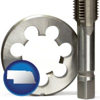 nebraska map icon and a metal die and a screw tap, isolated on a white background