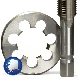 a metal die and a screw tap, isolated on a white background - with Alaska icon