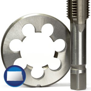 a metal die and a screw tap, isolated on a white background - with North Dakota icon